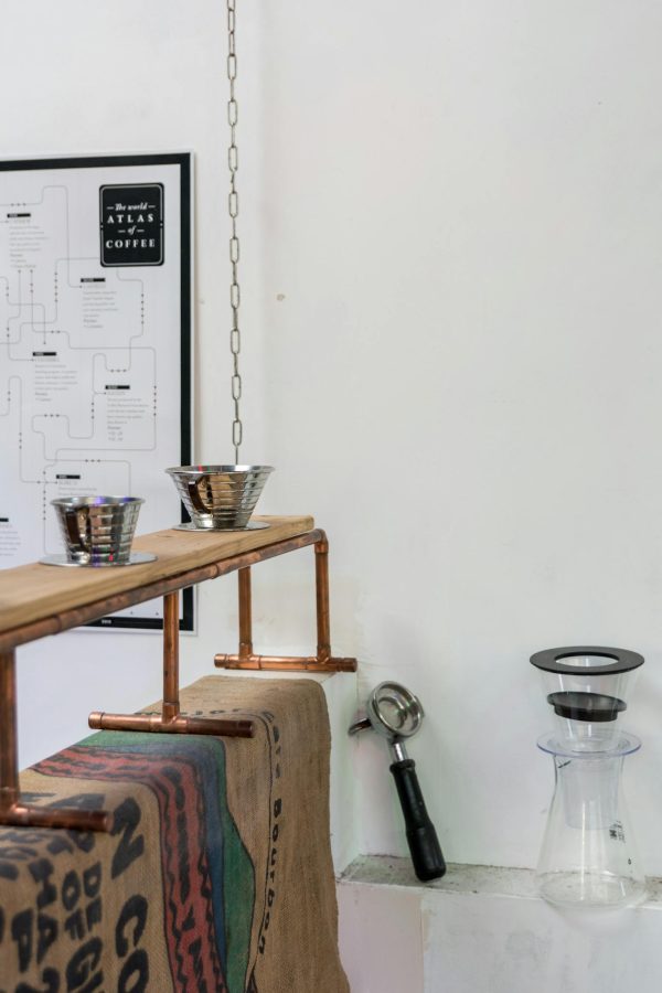 A stylish café interior featuring coffee brewing equipment and chic decor.